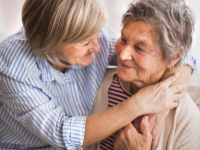 Woman hugging older adult