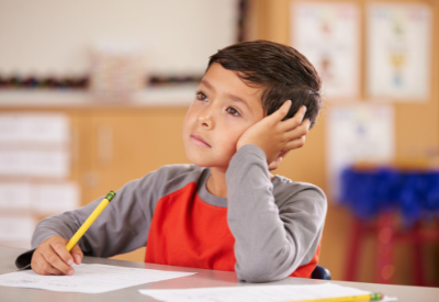 Young boy looking distracted in classroom