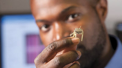 Kafui Dzirasa holding a small chip