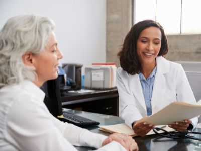 Psychologist talking with older adult patient