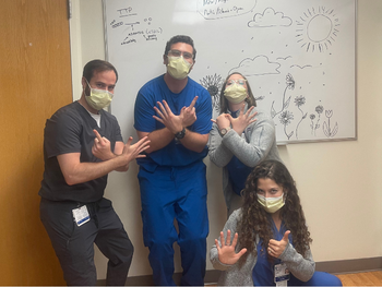 GM6 Elana Horwitz, John Barber, 2 med students making "6s" with their hands/fingers
