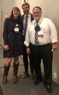 Martha Ward (AMP president) on left and Mike Lang (president-elect and Chair of Psychiatry at ECU) on right, with vignette award-winner, PGY4 Gregg Robbins-Welty, in the center.