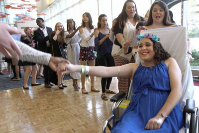 Isabel, a hospital patient, connects the conga line during the 2018 Children's Prom