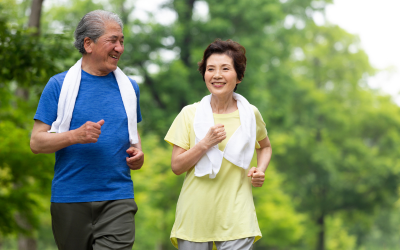 Older adult couple jogging on a nature path