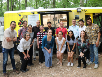 CAP fellows and several faculty members pose for a group photo in front of a food truck