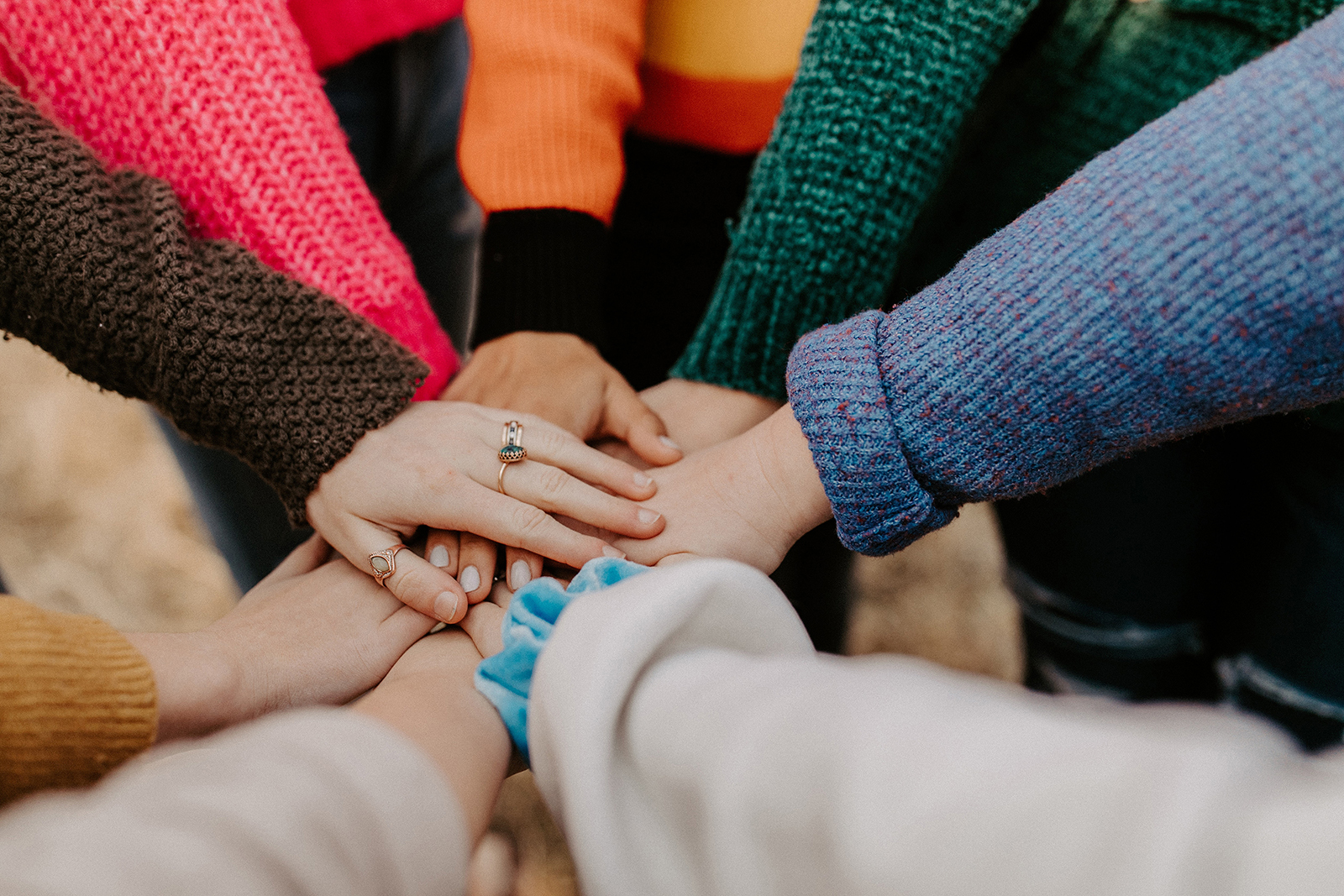 Women's hands stacked in a circle