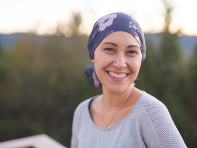 Smiling young woman with scarf on head standing in nature