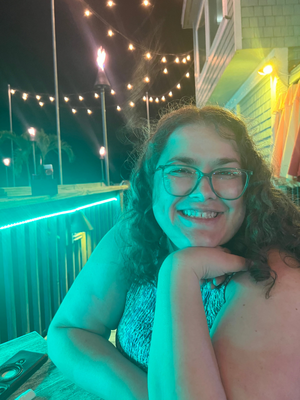 Carolina Nadal Medina on a lit-up porch at the beach