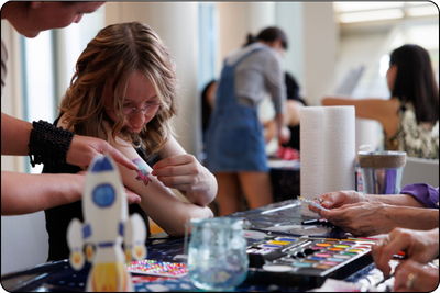Young girl at face painting station