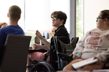 Young adults participating in a discussion in a classroom setting