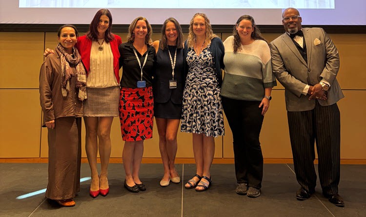 Seven team members who helped organize the research retreat