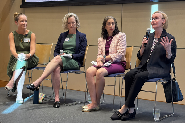 Four women panelists discuss research collaboration at a research retreat