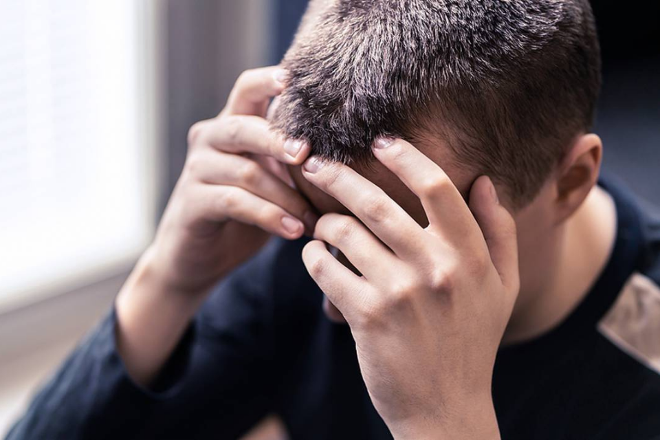 Man holding head in hands