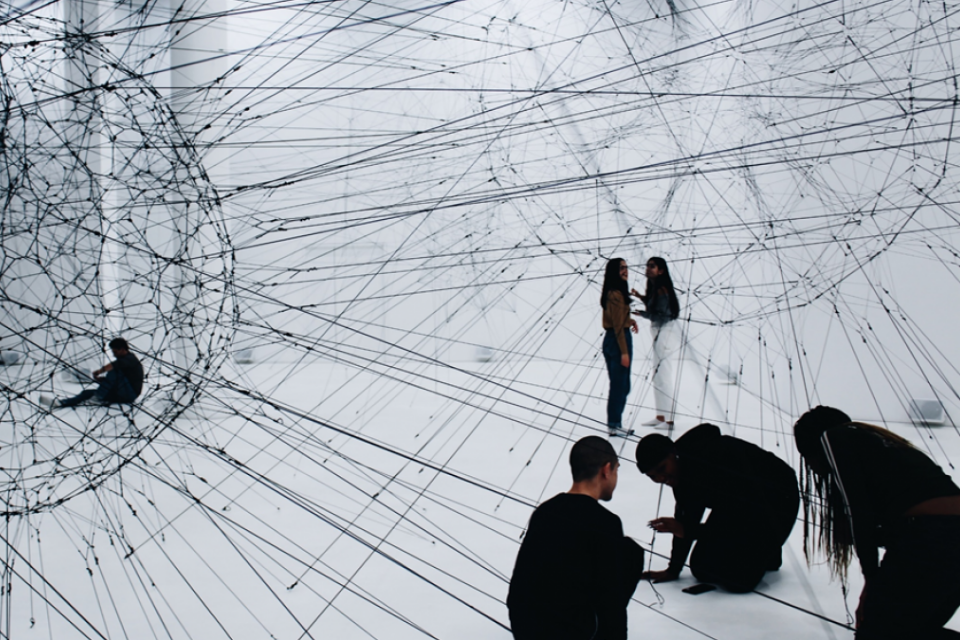Representative illustration of web of data, with people crouching in the foreground