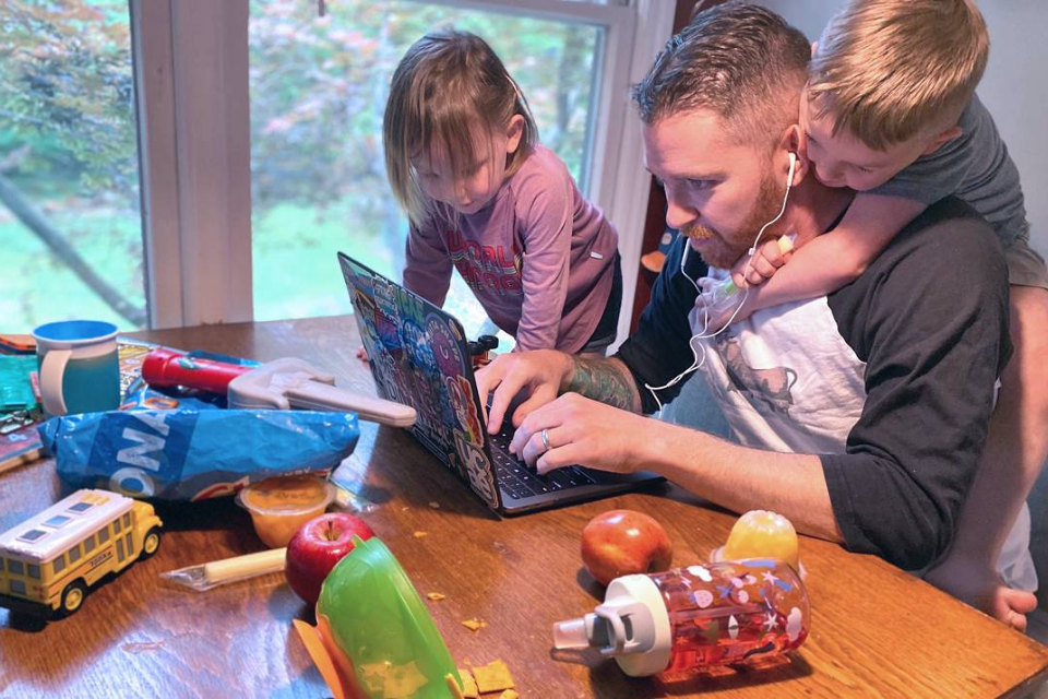 Kyle Fox with his children while trying to work from home. Kyle Fox of University Center Activities and Events has had to balance job duties and childcare while working from home. Photo courtesy of Kyle Fox.