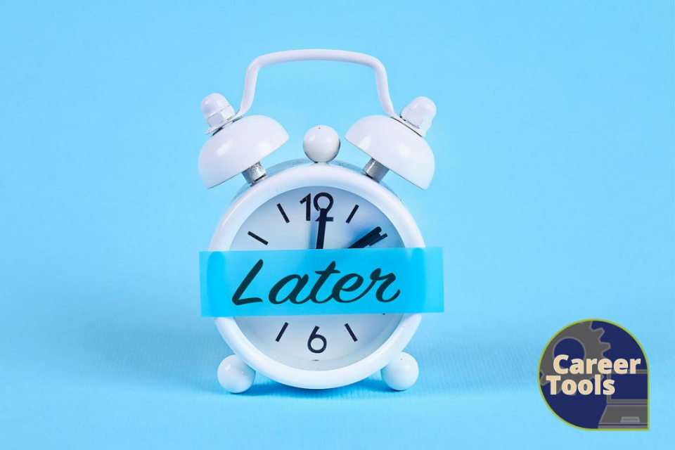 White alarm clock with banner "Later" draped across the front