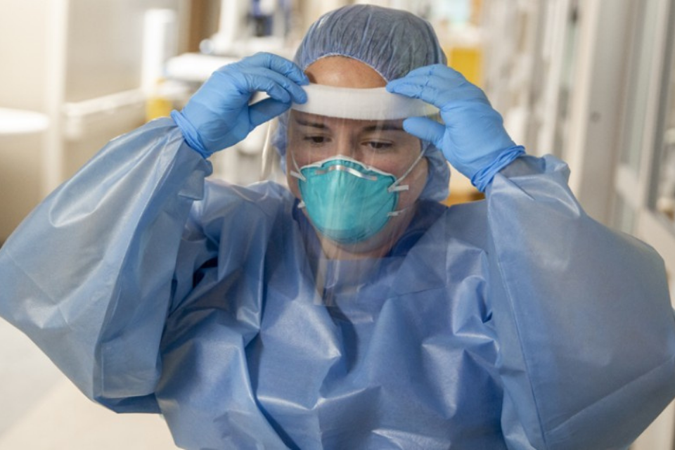 Healthcare professional with full PPE gear