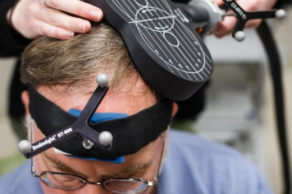Person performing magnetic brain stimulation