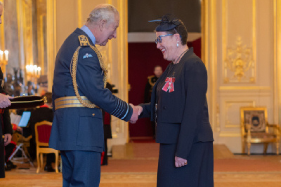 King Charles III presents Duke faculty Terrie Moffitt with the title "Member of the Most Excellent Order of the British Empire" on December 19, 2023. 