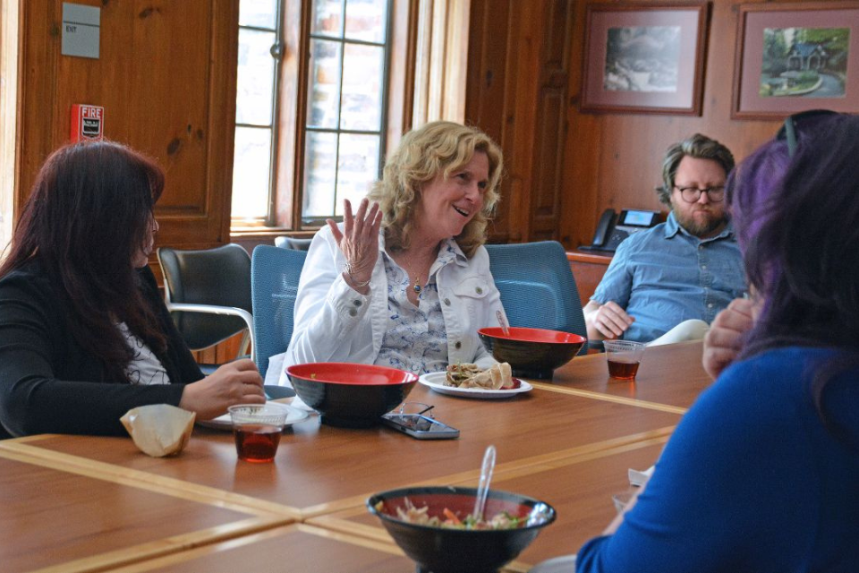 People sitting in a conference room eating lunch together