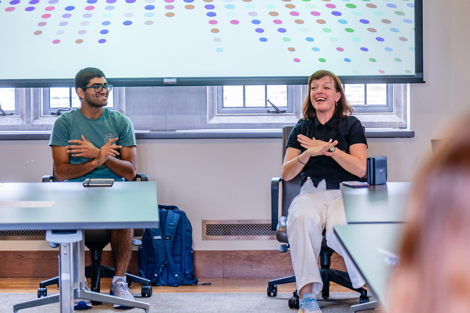Sarah Wilbur, Duke associate professor of the practice of dance and Re-Imagining Medicine Fellow Pranav Mukund dance during a seated movement session in the Rubenstein library. Photo credit: Summer Steenberg.