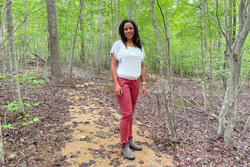 Nora Dennis on a path in the woods