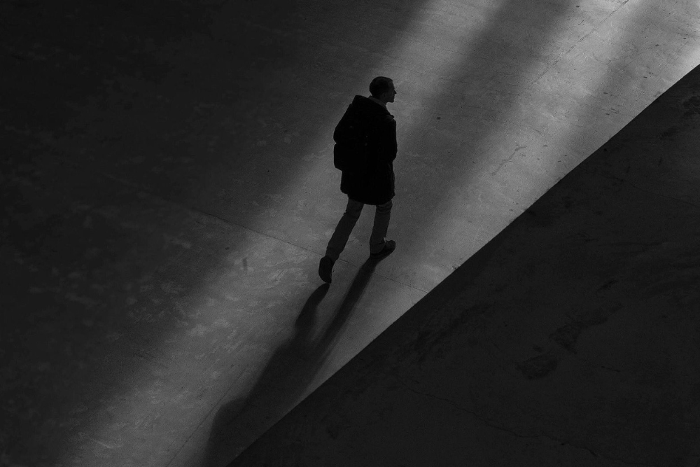 Silhouetted figure walking in the dark