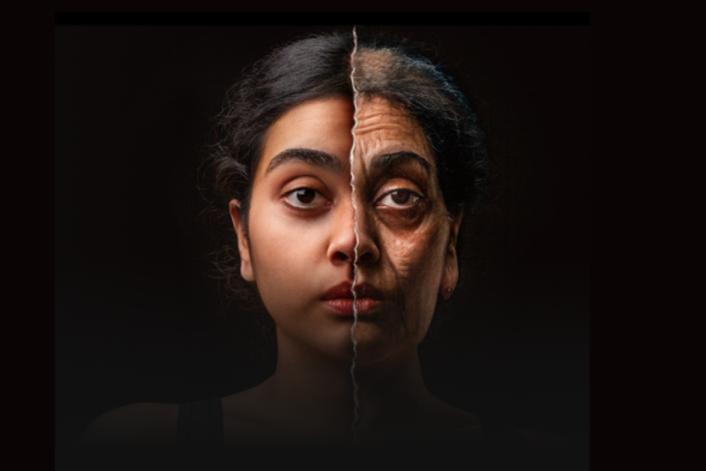 Black background; woman's face with right side of face looking younger and left side of face looking older.