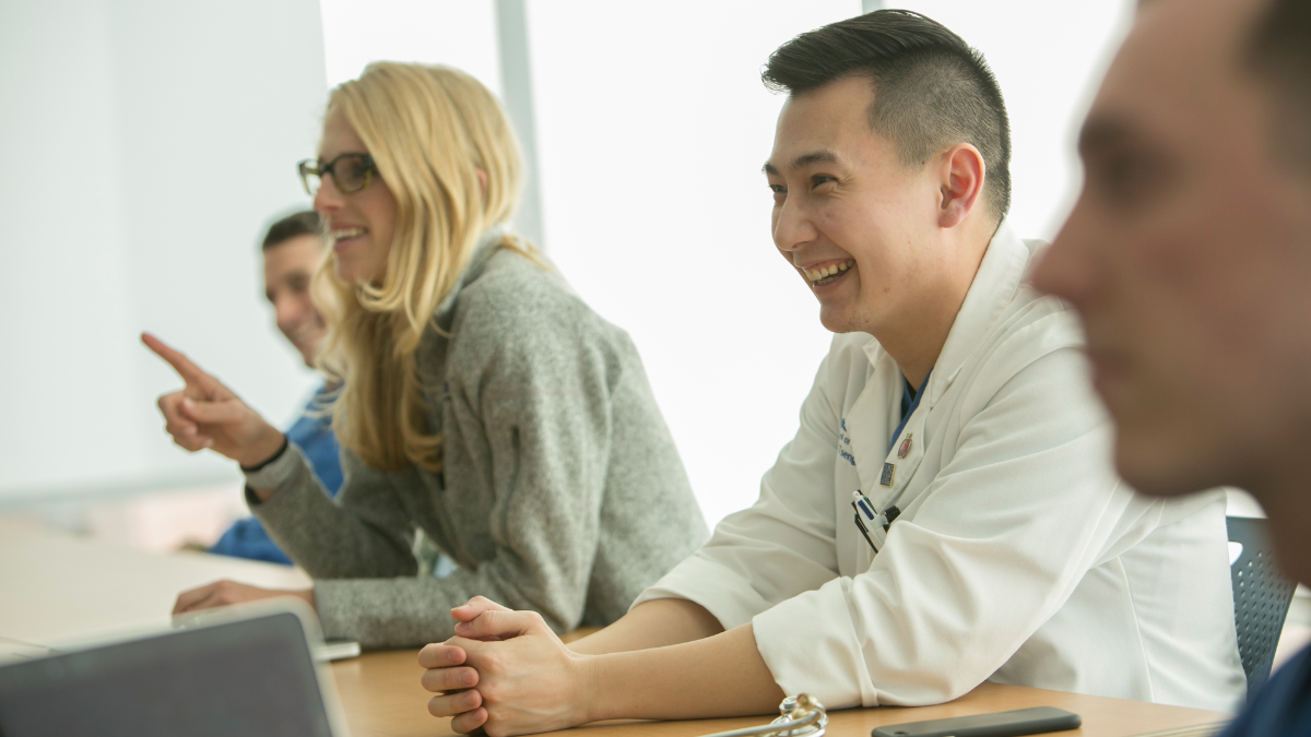 Four medical students engaged in classroom discussion