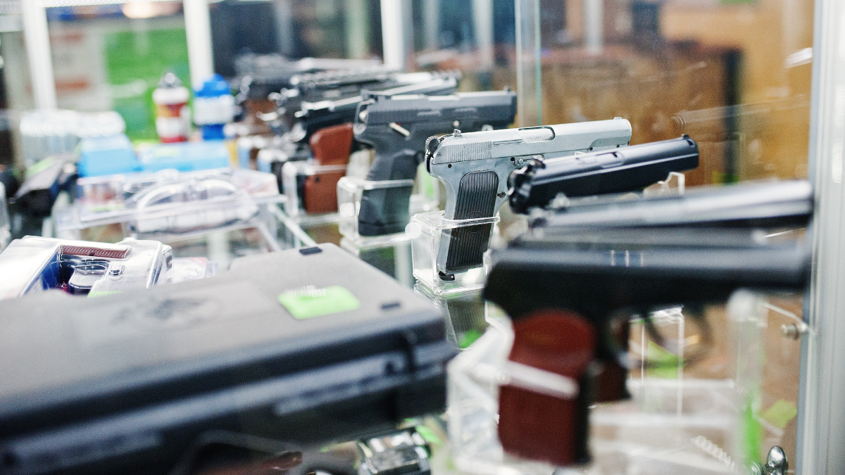 Guns behind a glass shield in a gun shop