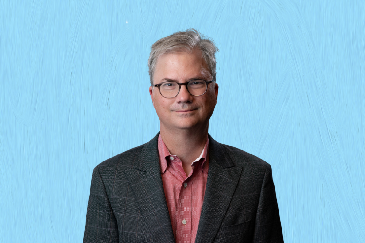 Headshot of Holden Thorp on light blue background