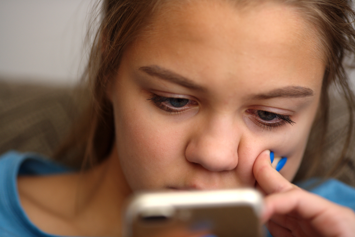 Close-up shot of young woman looking at her phone