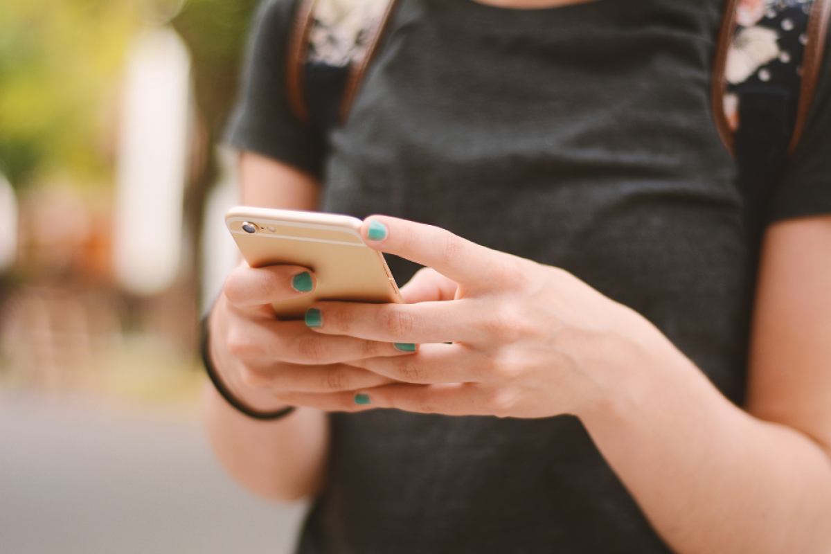 Young person texting. Only hands and phone showing.