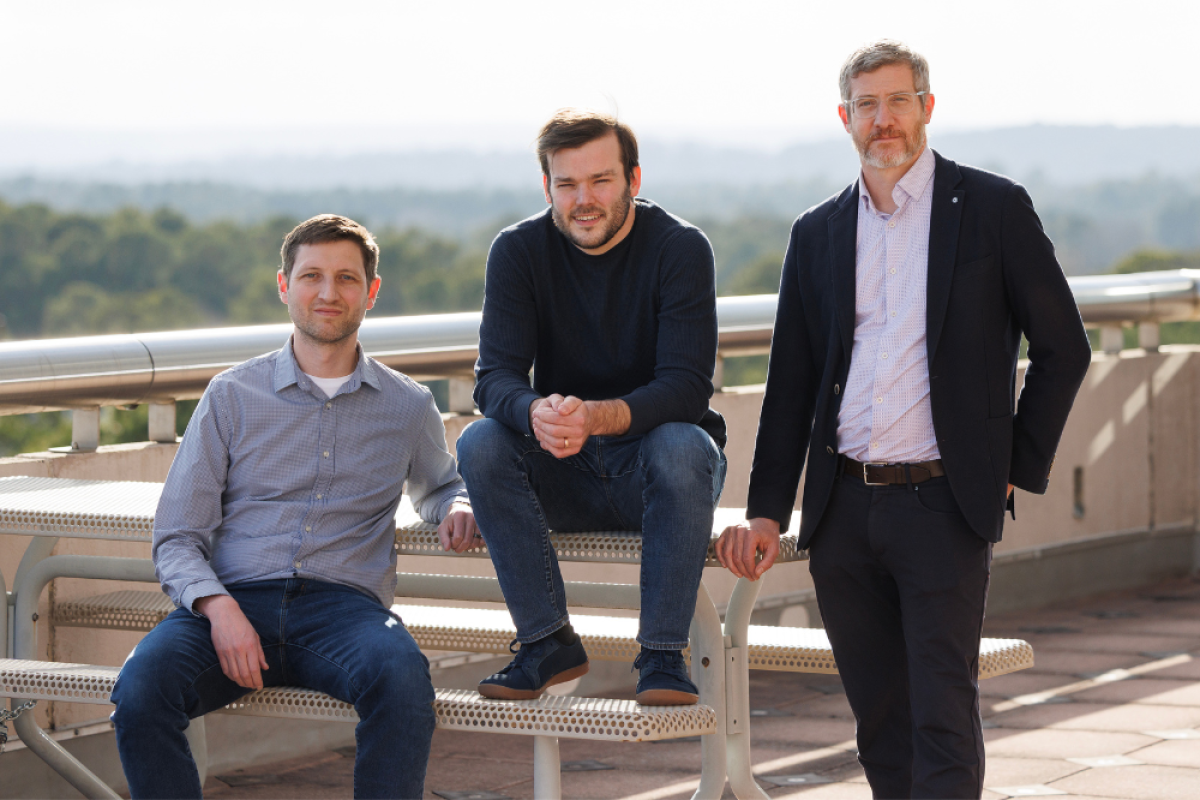 Left to right: Elliott Hill, Matt Engelhard, and Jonathan Posner at table on rooftop patio