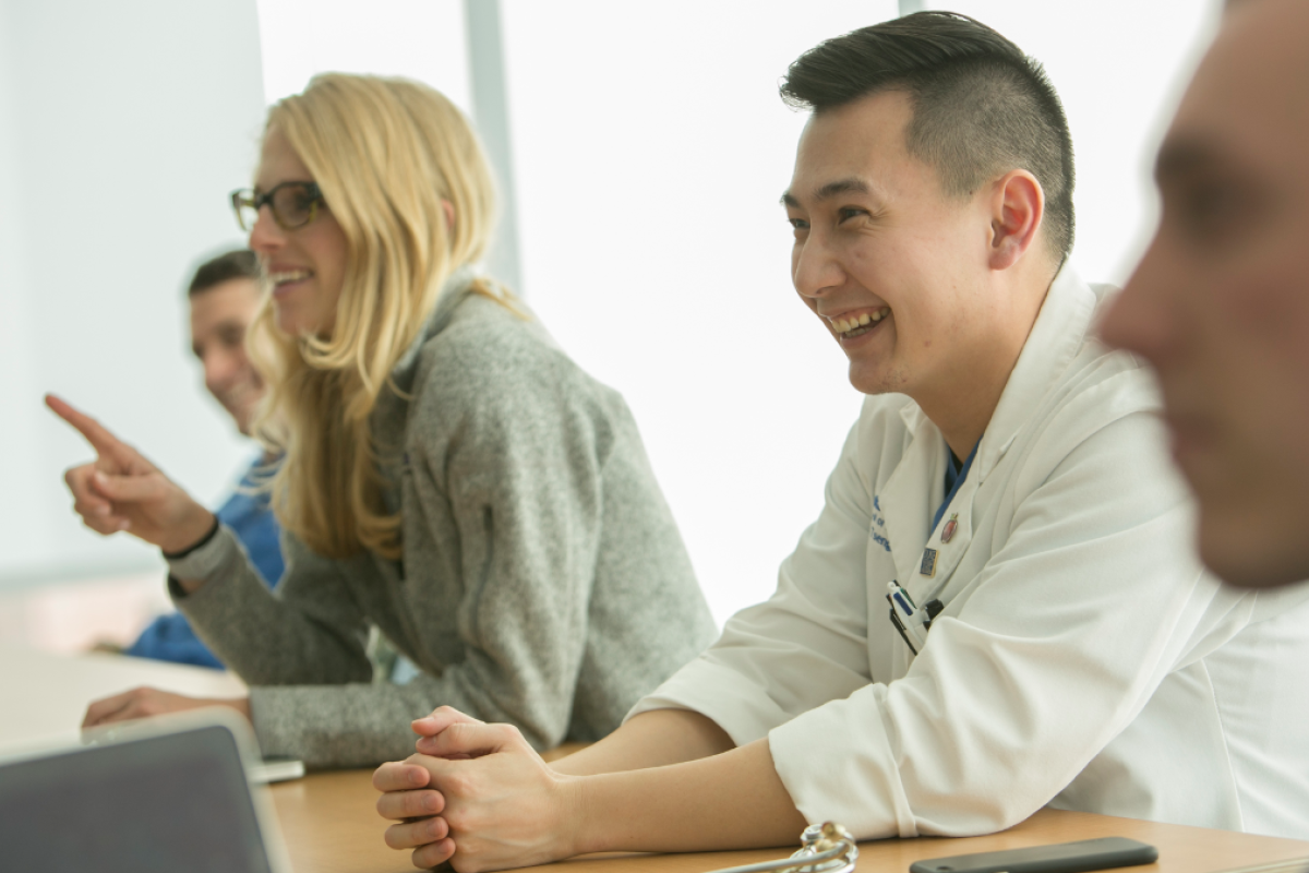 Four medical students engaged in classroom discussion