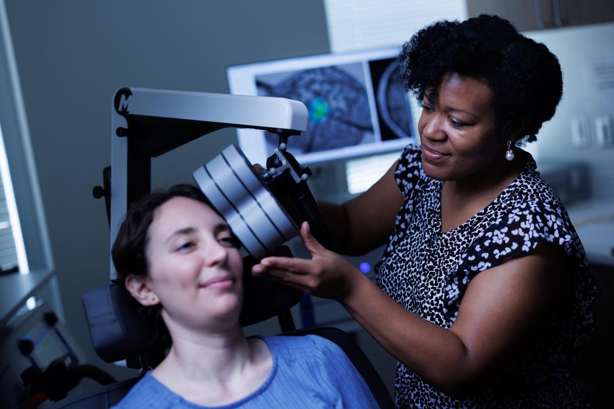 Tonisha Kearney-Ramos demonstrates rTMS on a patient actor