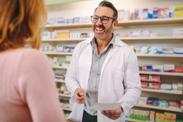 Pharmacist speaks with customer