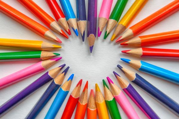 Colored pencils creating the shape of a heart