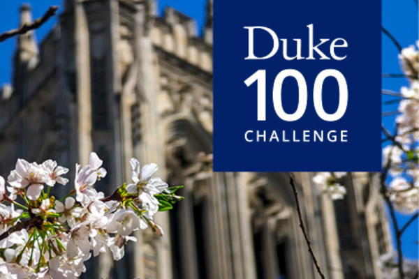 Duke University building with flowers in foreground. "Duke 100 Challenge."