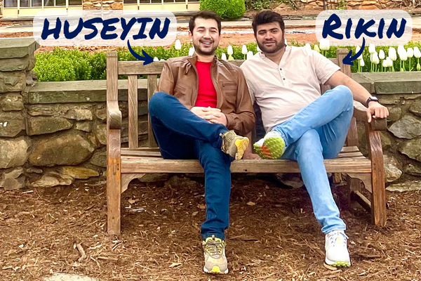 Rikin Patel (right) and co-fellow Huseyin Bayazit (left) sitting on a bench