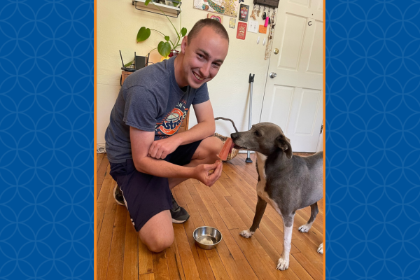 Alex treating his dog, Callie, a Whippet mix, with a dog food popsicle.
