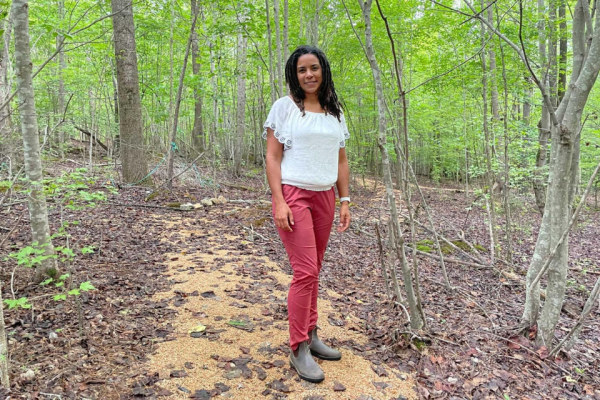 Nora Dennis on a path in the woods