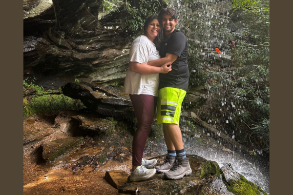 Shiva Kothari (right) and his wife (left) standing under a waterfall in North Carolina.