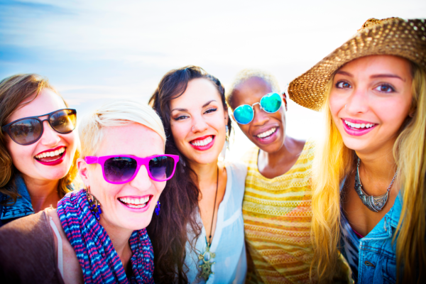 Young, diverse, smiling women outside