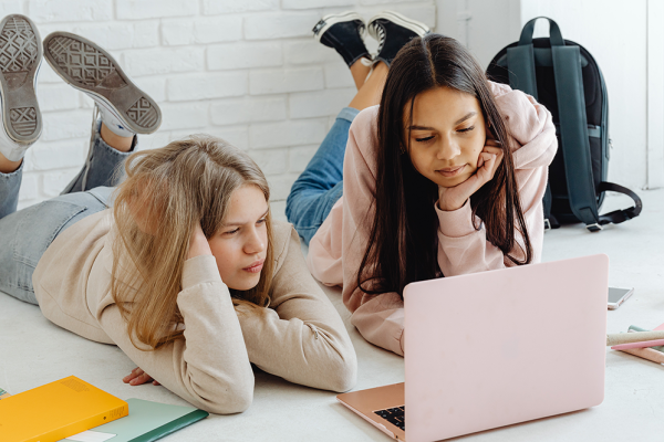 Adolescent girls looking at laptop