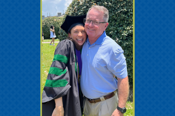 Rachel Landrum in graduation gown with father