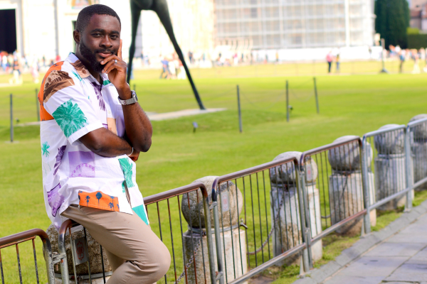 Soji Ojo in front of a building