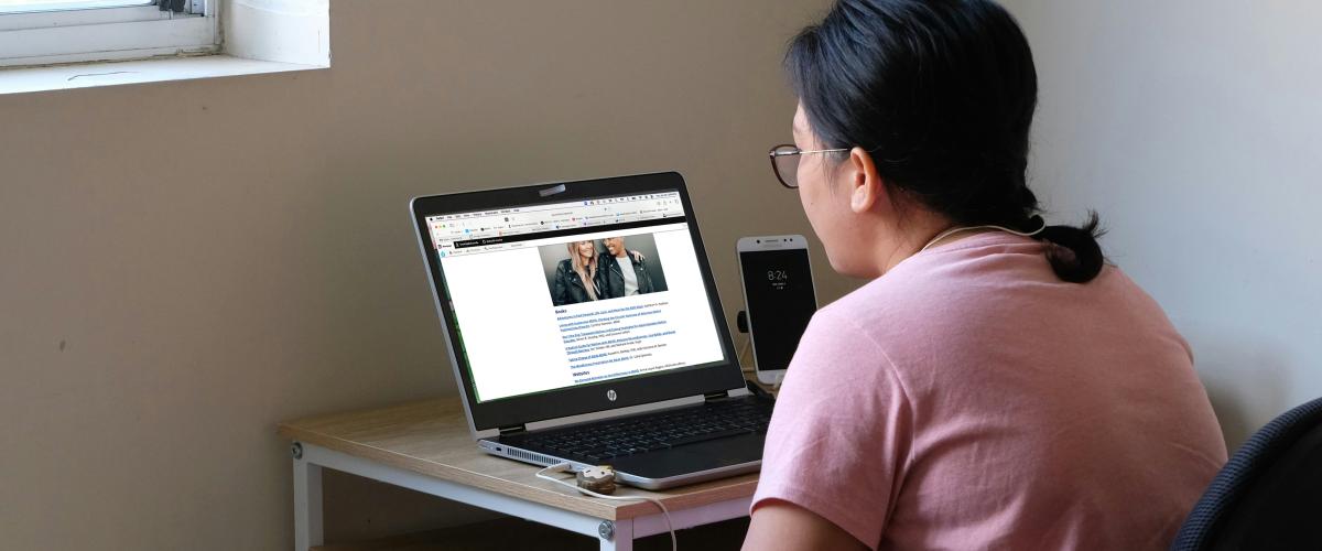Woman reading on her laptop
