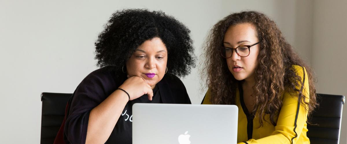 Two women looking at laptop