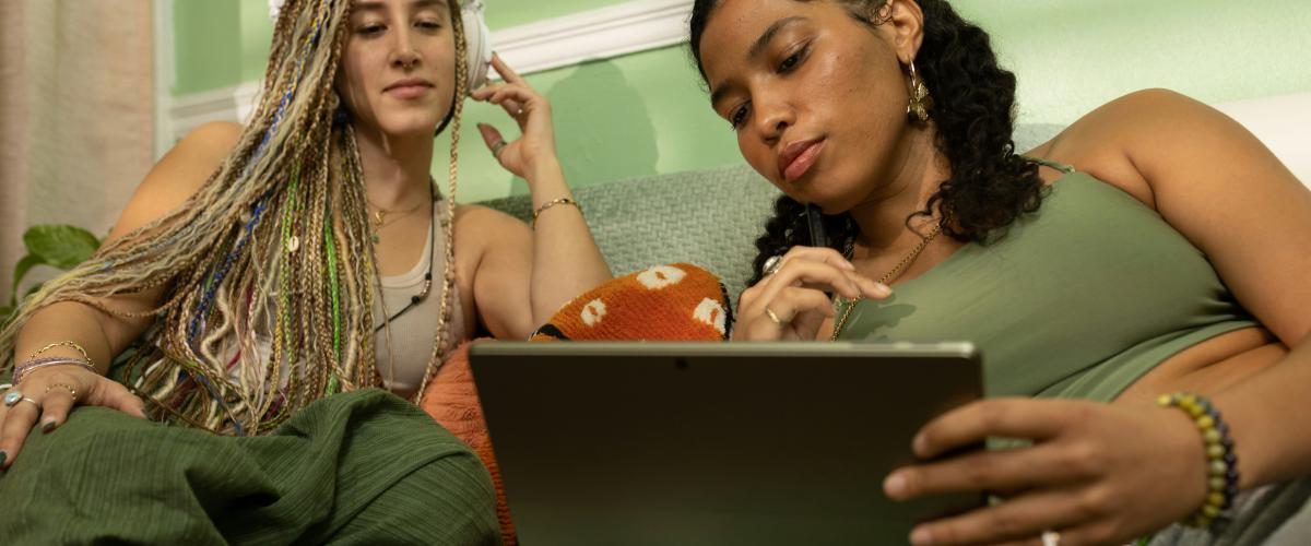 Two young women looking at a laptop